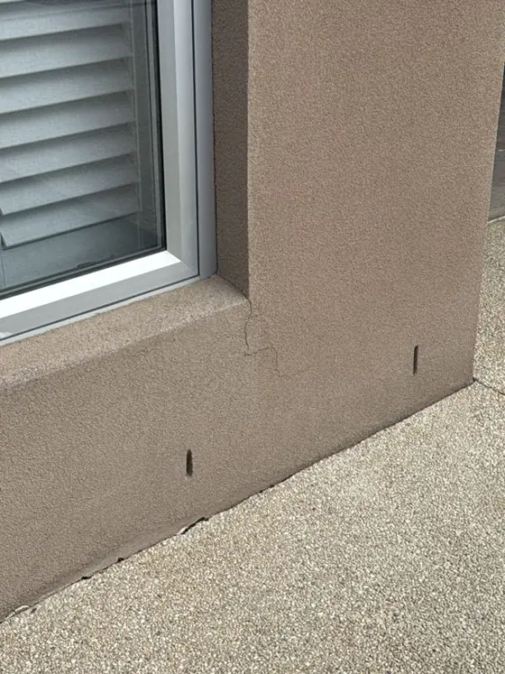 Crack in the render running down from the corner of a window